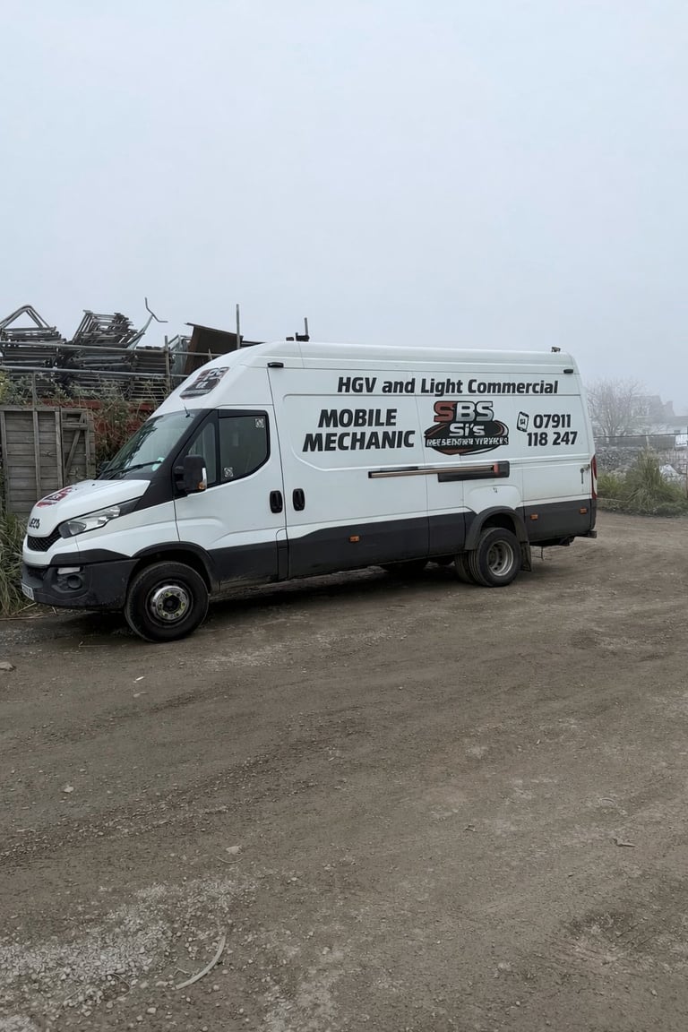 White and black mobile mechanic van parked on gravel with SBS branding and contact details visible on the side